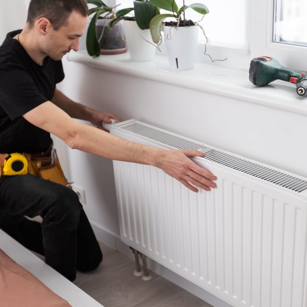 plumber at work. Installing water heating radiator. High quality photo